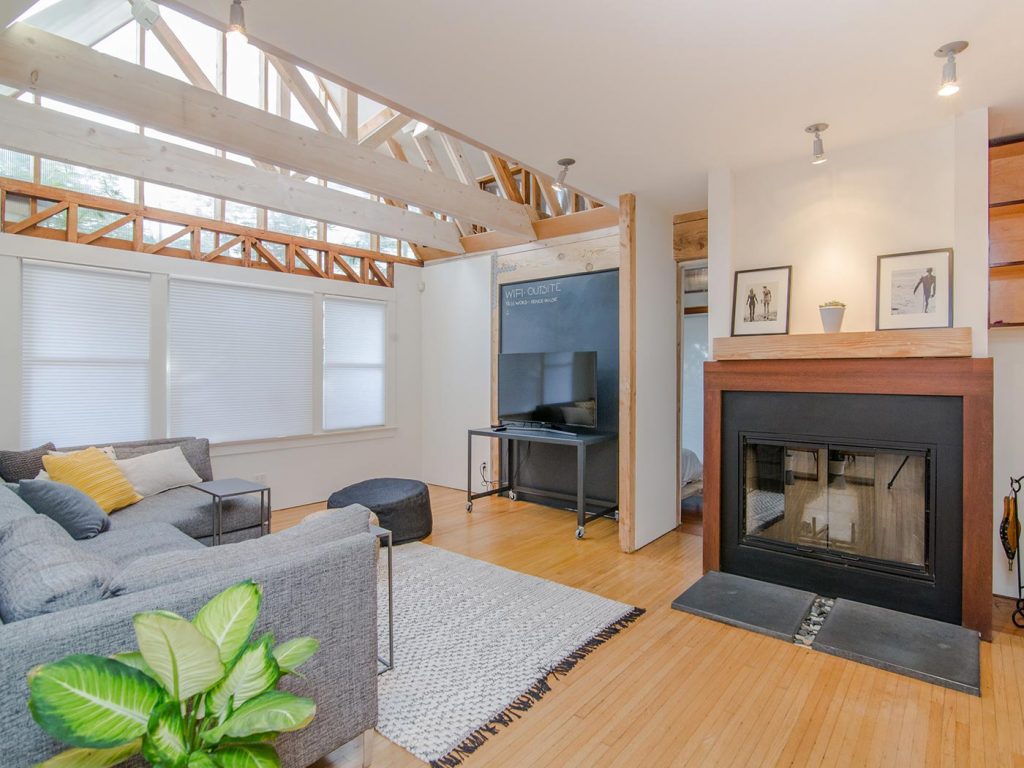 Renewable energy green home with a grey sofa, and&nbsp;natural lighting through the beams